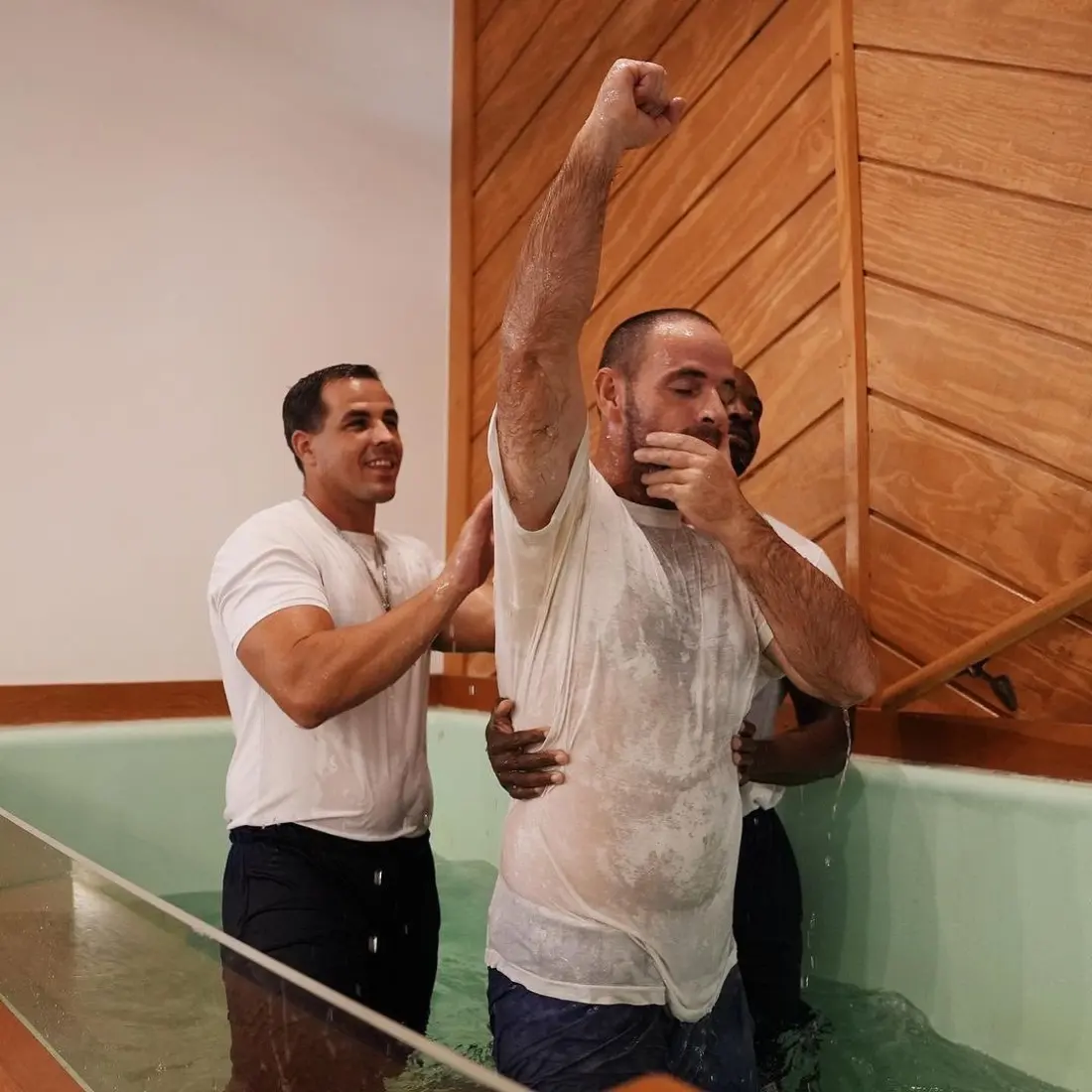 Gary Farrington baptizing a fellow inmate inside prison, both men in the water